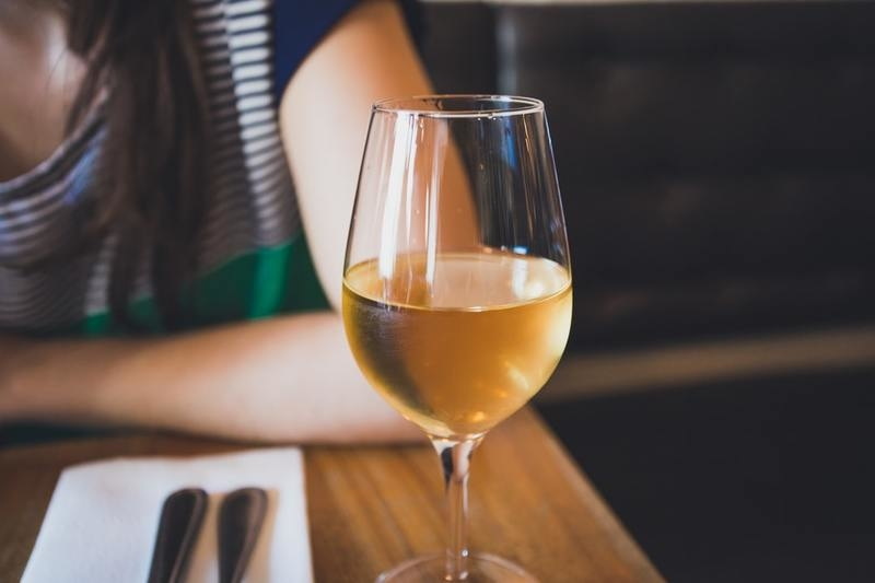 Glass of white wine on a table in a restaurant